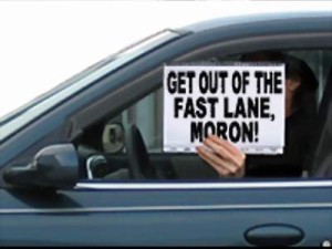 Diver holding sign "Get our of the fast lane, moron"